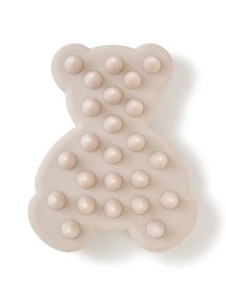 Bear shampoo brush in beige with massage protrusions for scalp and dirt removal.