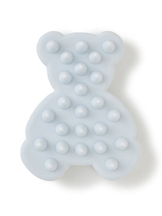 Light blue bear-shaped shampoo brush with massaging bristles for a gentle scalp cleanse.