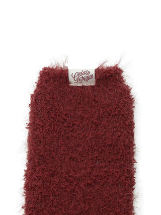 Close-up of red feather fuzzy socks showcasing the soft, textured fabric for a cozy winter feel.