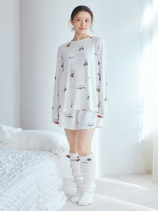 Model wearing Gelato Pique USA off-white panda long fuzzy socks and matching sleepwear, representing premium loungewear and sleepwear.