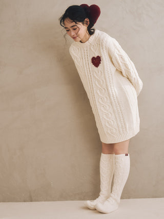 Woman wearing Heart Aran Long Socks and cable-knit sweater, highlighting cozy winter loungewear.