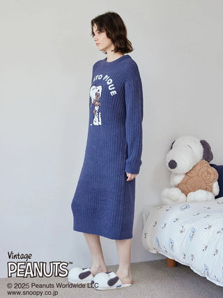 Person wearing SNOOPY×BEAR Jacquard Lounge Dress by Gelato Pique, standing beside plush Snoopy toy in a cozy room.