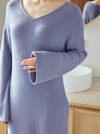 Close-up of a woman wearing a soft blue Classy Moco Maxi Lounge Dress with elegant drape and textured fabric from Gelato Pique.