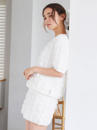 Woman wearing Bubble Moco Fleece Shorts and matching top, showcasing cozy white fleece texture and stylish lounging comfort.