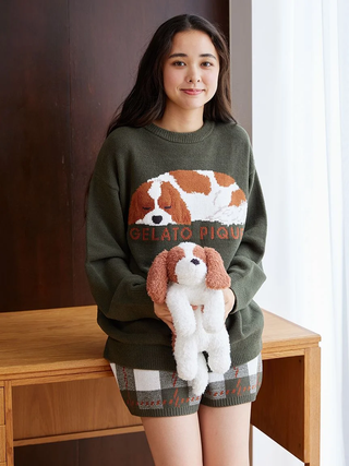 Woman wearing Gelato Pique sweater and Air Moco checkered lounge shorts holding a plush dog.