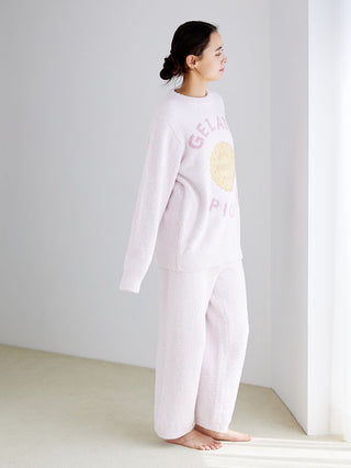 Woman wearing Powder Biscuit Embroidered Lounge Pants and matching top by Gelato Pique, standing in a bright room.