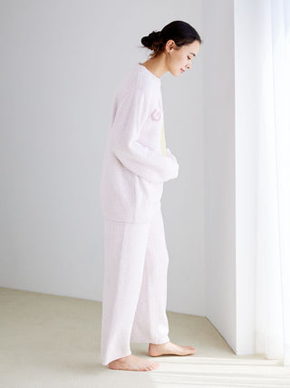 Woman wearing Powder Biscuit Embroidered Lounge Pants in a soft, plush fabric, perfect for cozy relaxation at home.