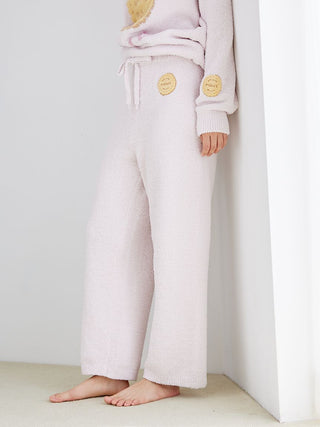 Woman wearing Powder Biscuit Embroidered Lounge Pants with soft fabric and cozy design, ideal for relaxing at home.