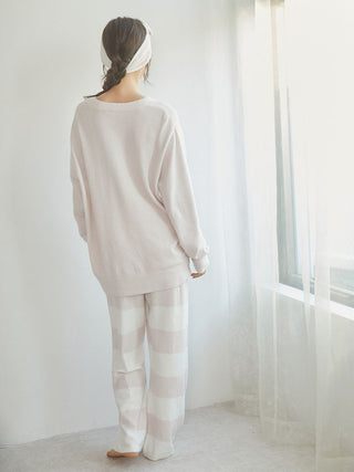 Model wearing Smoothie 2-Border Pants and a cozy sweater, showcasing soft pastel stripes and a relaxed fit.