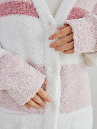 Woman wearing a powder melange striped long cardigan with pink and white stripes, highlighting button details and soft texture.