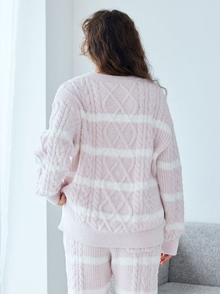 Woman wearing Baby Moco Aran Pullover Sweater with pink stripes and cable knit pattern, showcasing cozy fabric and elegant design.