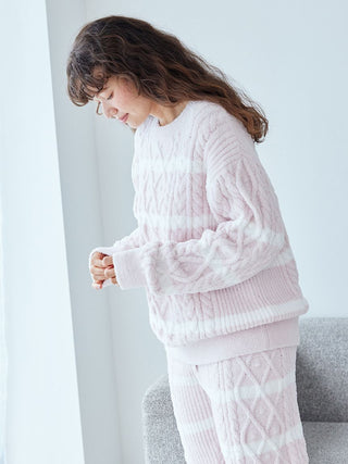 Woman wearing Baby Moco Aran Pullover Sweater by Gelato Pique with pink Aran cable knit and horizontal stripes.