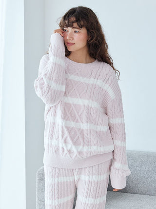 Woman wearing Baby Moco Aran Pullover Sweater with cable knit pattern and stripes, showcasing cozy and stylish design.