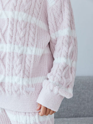 Soft pink Baby Moco Aran pullover sweater with white stripes, intricate cable knit design, and ultra-soft fabric for cozy days.