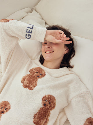 Woman relaxing in plush Toy Poodle Pullover Sweater with adorable poodle motifs, showcasing softness and warmth by Gelato Pique.