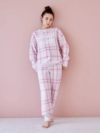 Woman wearing Gelato Pique checkered pajama set in pastel tones, showcasing soft and cozy loungewear.