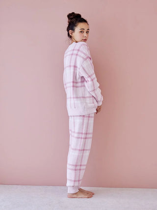 Woman wearing a pastel checkered pajama set, showcasing soft and cozy loungewear style.