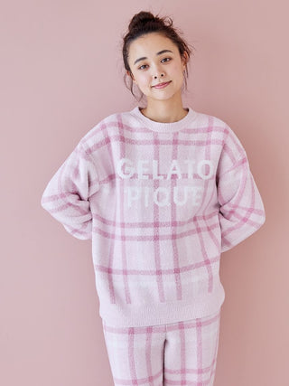 Woman wearing Gelato Pique checkered pajama set in pastel shades, showcasing cozy and stylish loungewear.