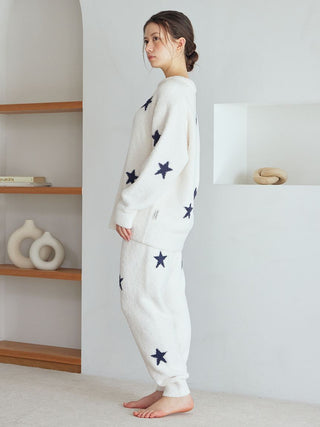 Woman wearing a cozy Gelato Pique USA off-white star-patterned pullover for premium home lounging and sleepwear.