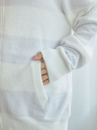 Close-up of the white and pastel striped sleeve of the 2025 Smoothie Parka showing pocket and embroidery detail.