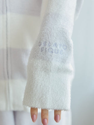 Close-up of a white knit parka sleeve with 'Gelato Pique' embroidery and soft texture, showcasing a stylish and cozy design.