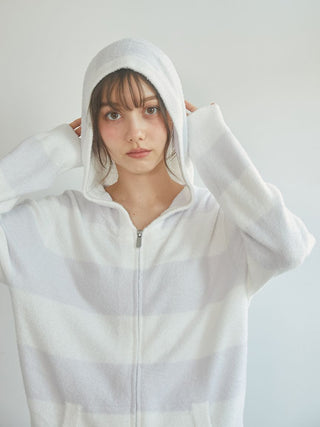 Model wearing the 2025 Smoothie 2-Border Parka in pastel stripes with a hood, showcasing its soft fabric and stylish design.