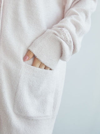 Close-up of a soft pink Smoothie cardigan showcasing the front pocket and embroidered sleeve detail.