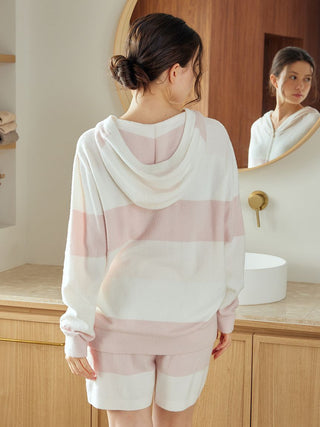 Woman wearing Gelato Pique USA Durable Smoothie Border Comfort Hoodie, showcasing premium loungewear in a cozy bathroom setting.