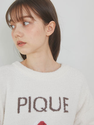 Model wearing the Cake Jacquard Pullover Sweater by Gelato Pique USA, featuring a cozy knit fabric with 'PIQUE' lettering.