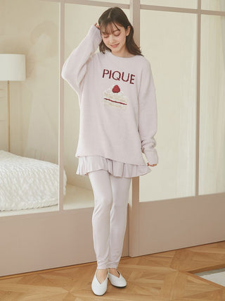 Woman wearing Cake Jacquard Pullover Sweater with cake motif and 'PIQUE' lettering, cozy loungewear by Gelato Pique USA.