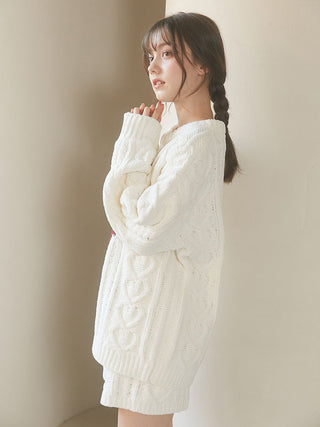 Woman wearing a cozy Heart Aran Pullover Sweater with intricate cable-knit heart motifs from Gelato Pique USA.