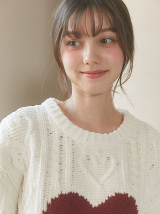 Woman wearing Heart Aran Pullover Sweater featuring cable-knit and heart design by Gelato Pique USA.