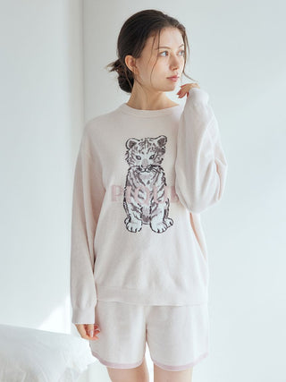 Woman in pale loungewear set with white tiger print by Gelato Pique USA, featuring premium knit pullover and shorts, ideal sleepwear.