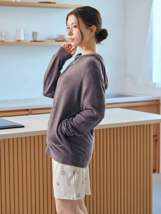 Woman wearing Smoothie Lite Hoodie Jacket by Gelato Pique USA in a modern kitchen, showcasing premium loungewear and sleepwear.