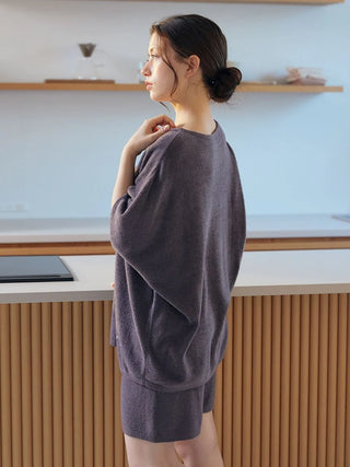 Woman wearing Smoothie Lite pullover in a kitchen, showcasing premium loungewear by Gelato Pique USA. Perfect for spring and summer.