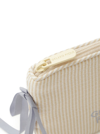 Close-up of Striped Ribbon Tissue Pouch in beige with charming ribbons, by Gelato Pique USA. Perfect for premium loungewear and sleepwear.