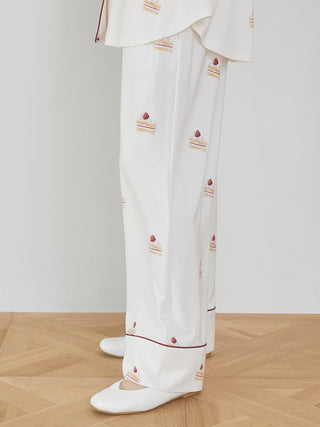 Strawberry shortcake-print long pants in silky rayon fabric with piping details, showcasing a sweet dessert motif for comfortable loungewear.