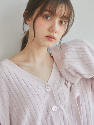 Close-up of woman wearing the 2025 Ribbed Cardigan in soft knit fabric, showcasing its elegant and cozy design with button details.